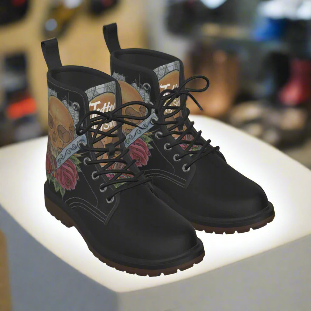 Black boots with colorful design on the side on a white background