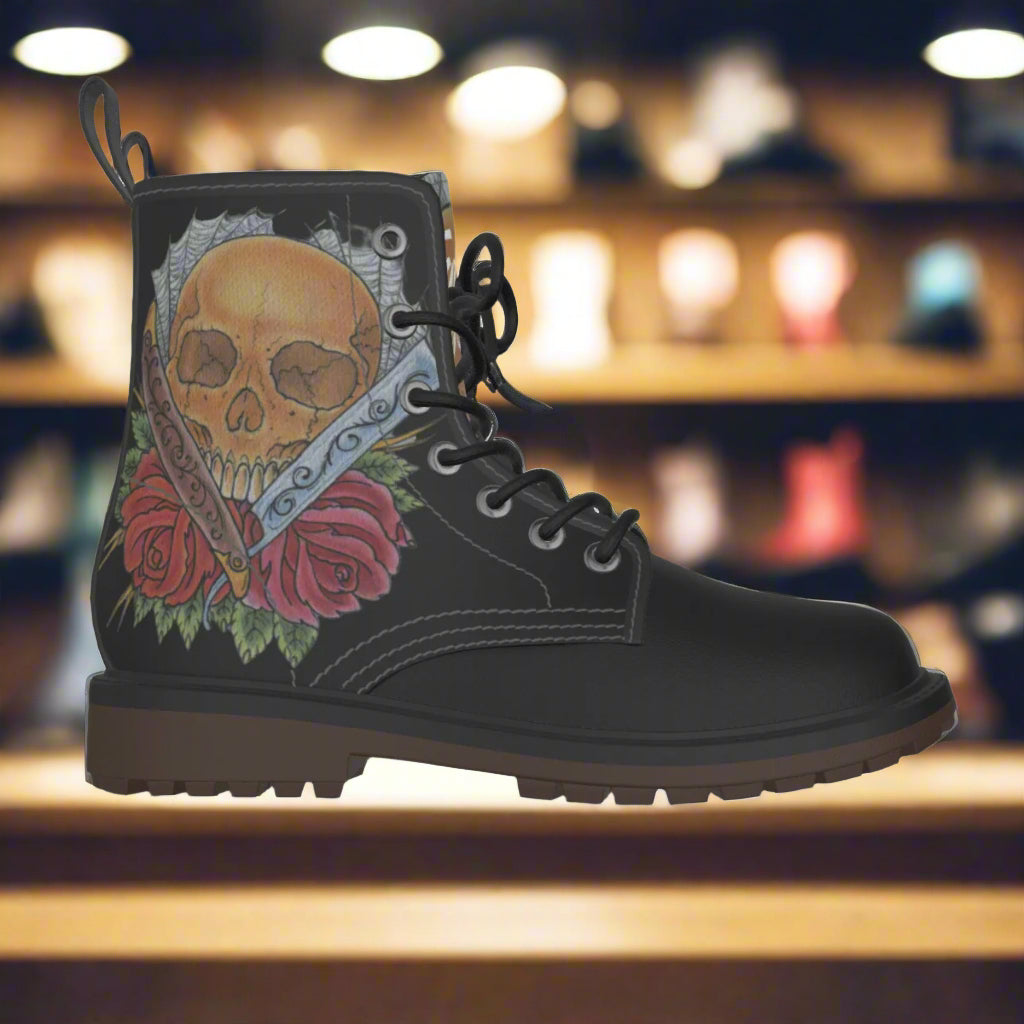 Black boot with skull and rose design on a white background