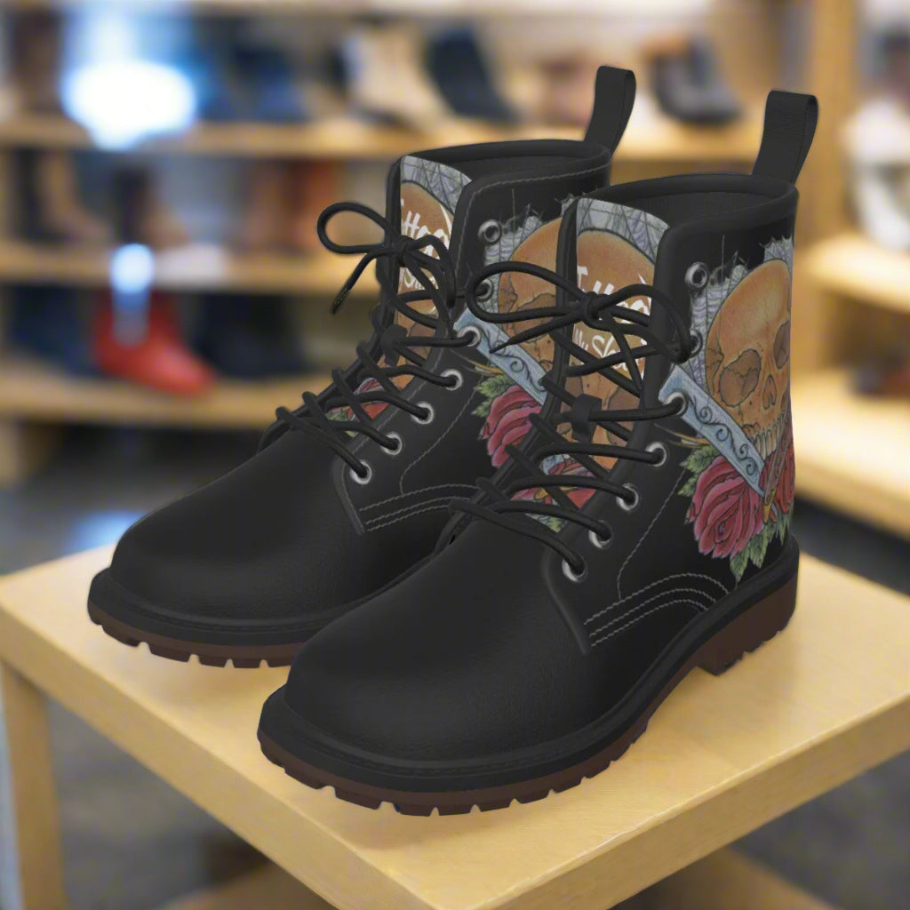 Black boots with colorful skull and floral design on a white background