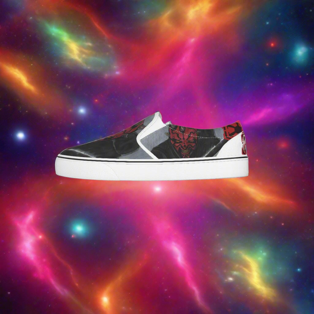 Black and white slip-on sneaker with red and gray pattern on a white background