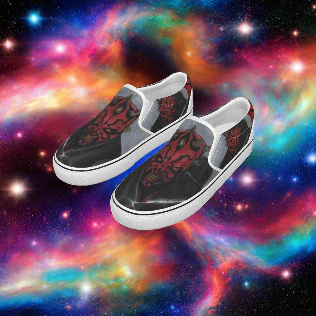 Pair of slip-on shoes with a red and black design on a white background