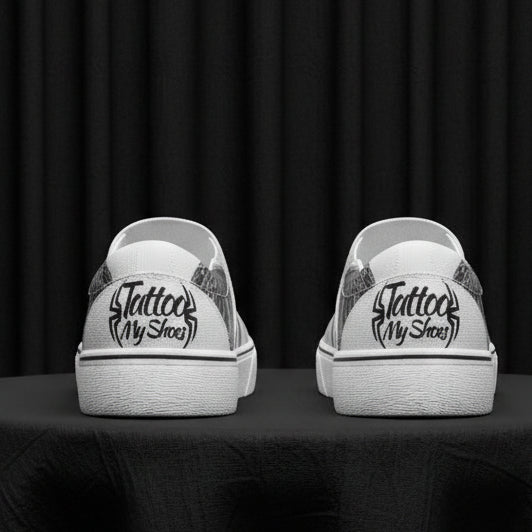 White sneakers with black text and graphics on a white background