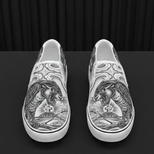 Silver slip-on shoes with intricate designs on a white background