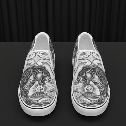 Silver slip-on shoes with intricate designs on a white background