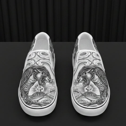 Silver slip-on shoes with intricate designs on a white background
