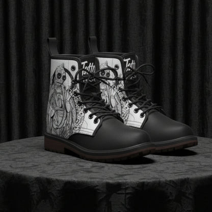 Black boots with white side panels featuring black designs on a white background