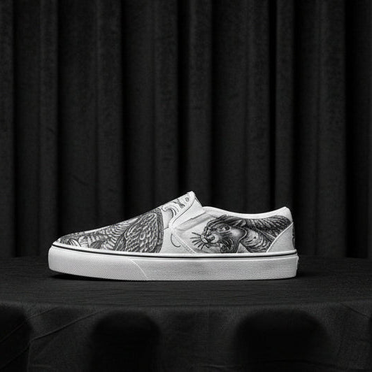 White slip-on sneaker with black and white tiger design on a white background