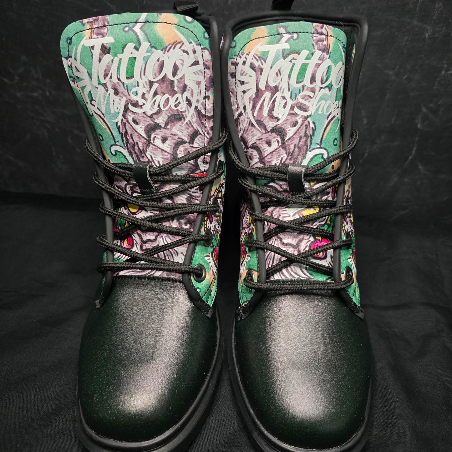 Pair of sneakers with colorful pattern on the side and black soles on a dark background