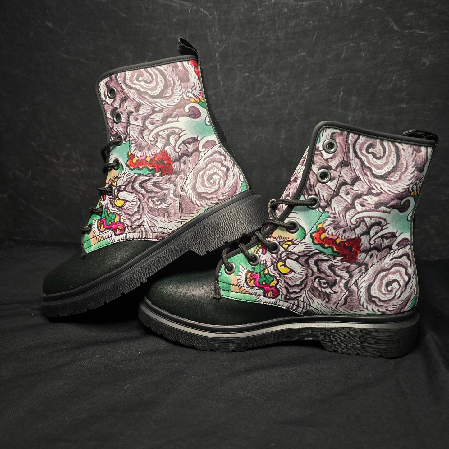 Pair of boots with intricate pattern on a black background