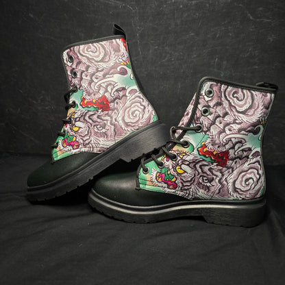 Pair of boots with intricate pattern on a black background