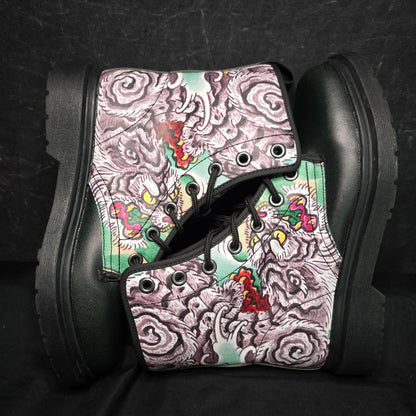 Black boots with a colorful, patterned design on a dark background