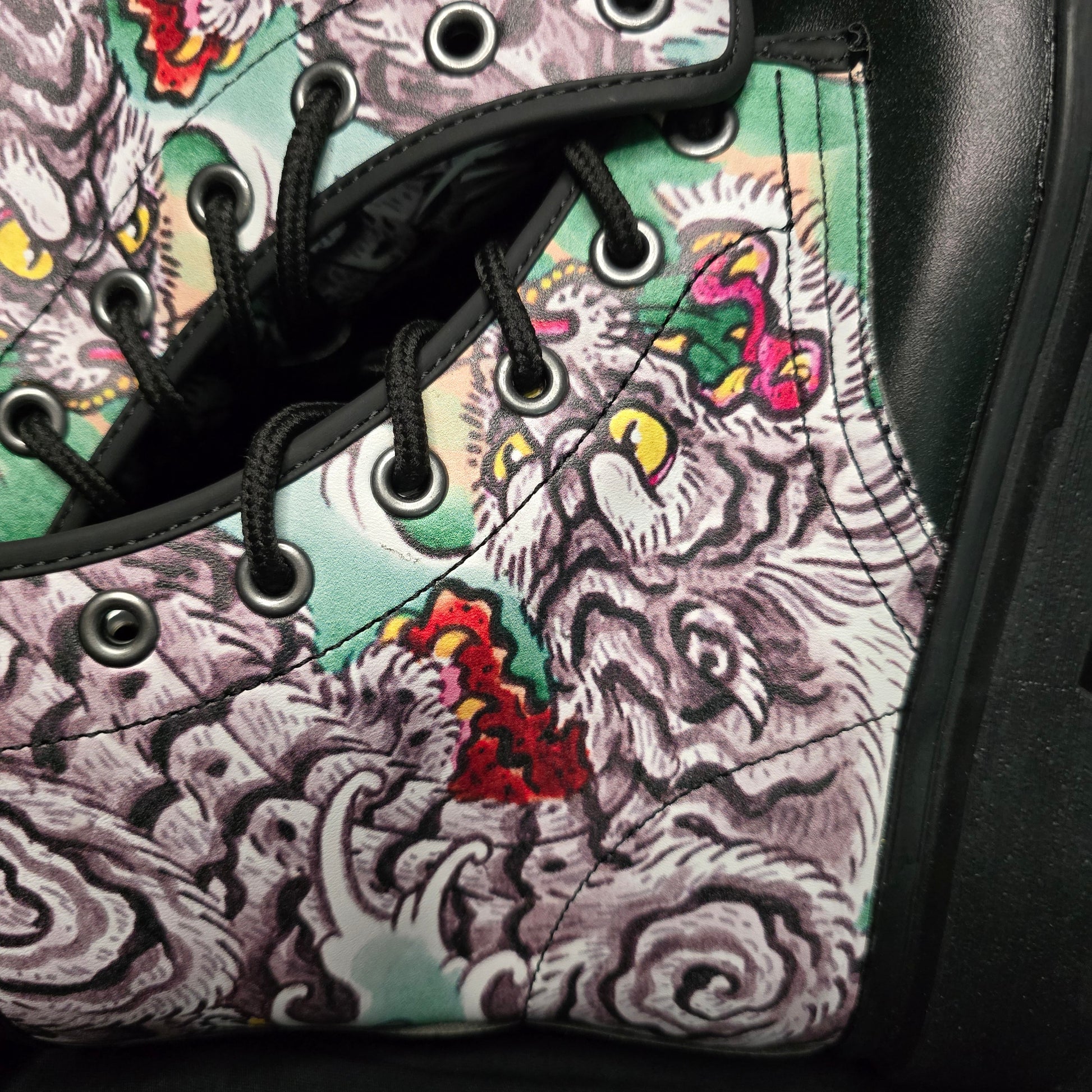 Close-up of a shoe with a colorful tattoo-style pattern on the side.