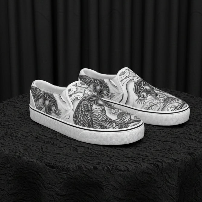 Silver slip-on shoes with intricate designs on a white background