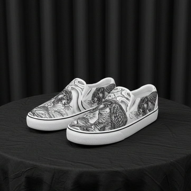 White slip-on shoes with black tattoo-style designs on a white background