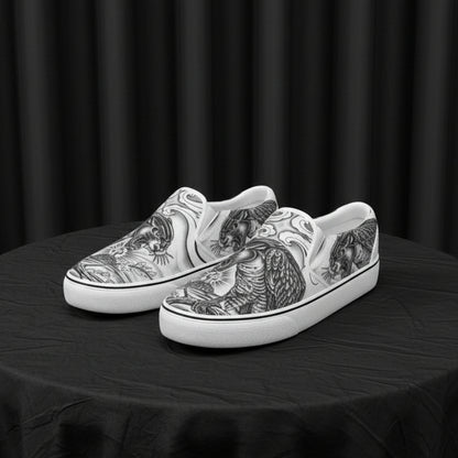 White slip-on shoes with black tattoo-style designs on a white background
