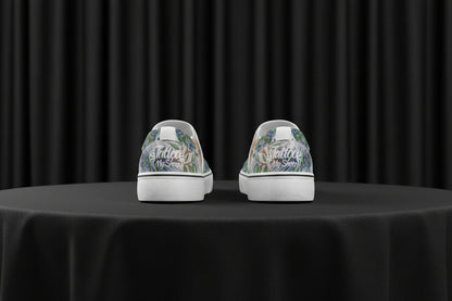 Pair of sneakers with floral pattern and text on a white background