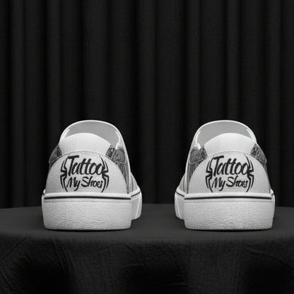 White sneakers with black text and graphics on a white background