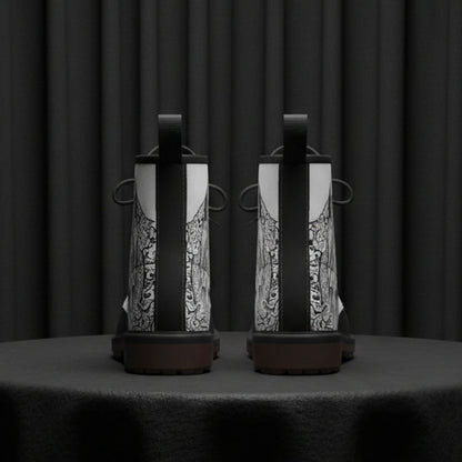 Pair of black and white boots with intricate patterns on a white background