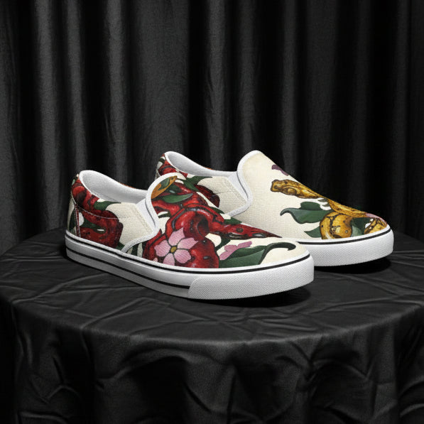 Pair of loafers with floral and Snake design on a white background
