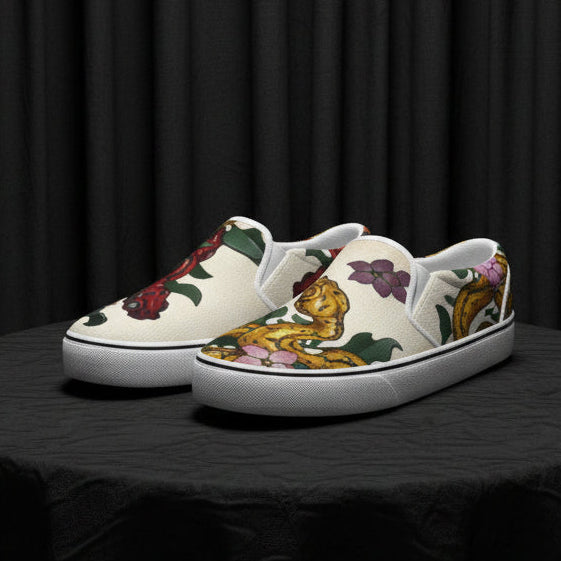 Pair of slip-on shoes with floral and teapot design on a white background