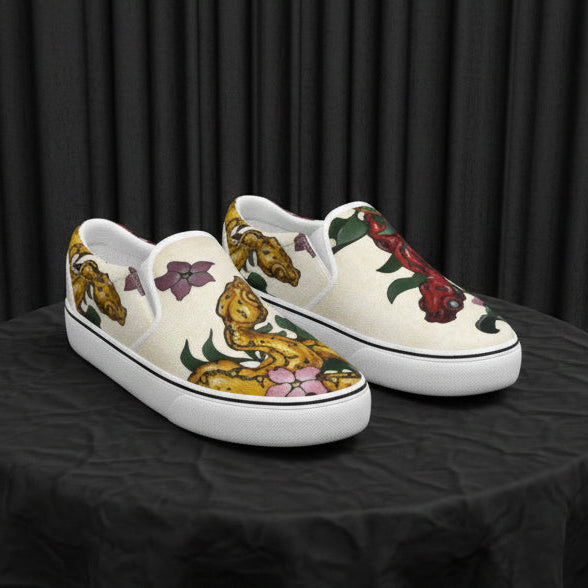 Pair of slip-on shoes with artistic designs on a white background