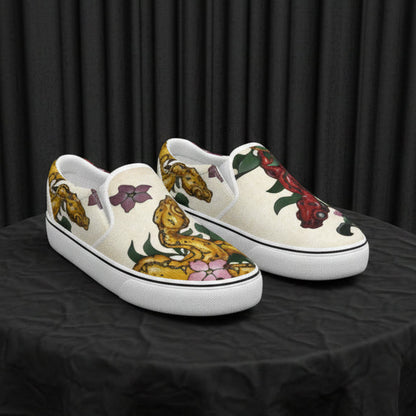 Pair of slip-on shoes with artistic designs on a white background
