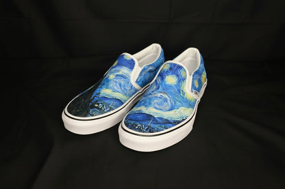 Pair of slip-on shoes with a Starry Night design on a black fabric background